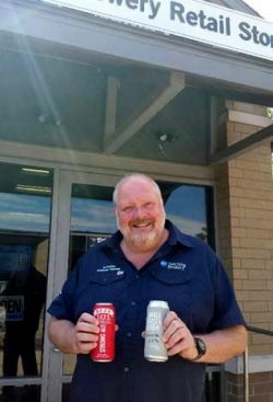 Niagara College brewmaster and professor Jon Downing with  award-winning Niagara College Teaching Brewery beers: Beer 101 Strong, which won bronze at the U.S. Open Beer Championships, and 16-73 Pils, which won gold at the U.S. Open College Beer Championships.