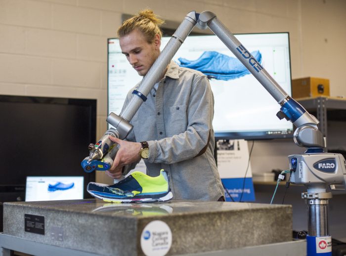Student research assistant Brock Husak uses 3D scanning technology as part of an industry partner project, in the Walker Advanced Manufacturing Innovation Centre, located on the Welland Campus.