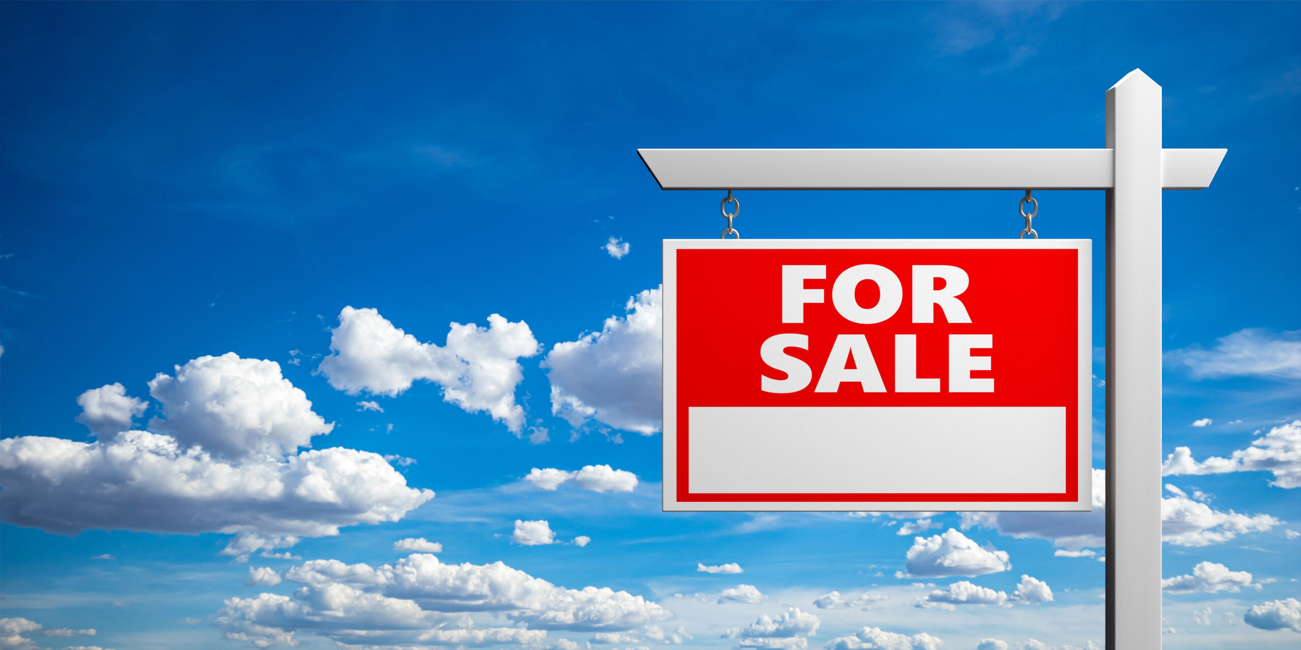 A red For Sale sign hangs from a post against a blue sky
