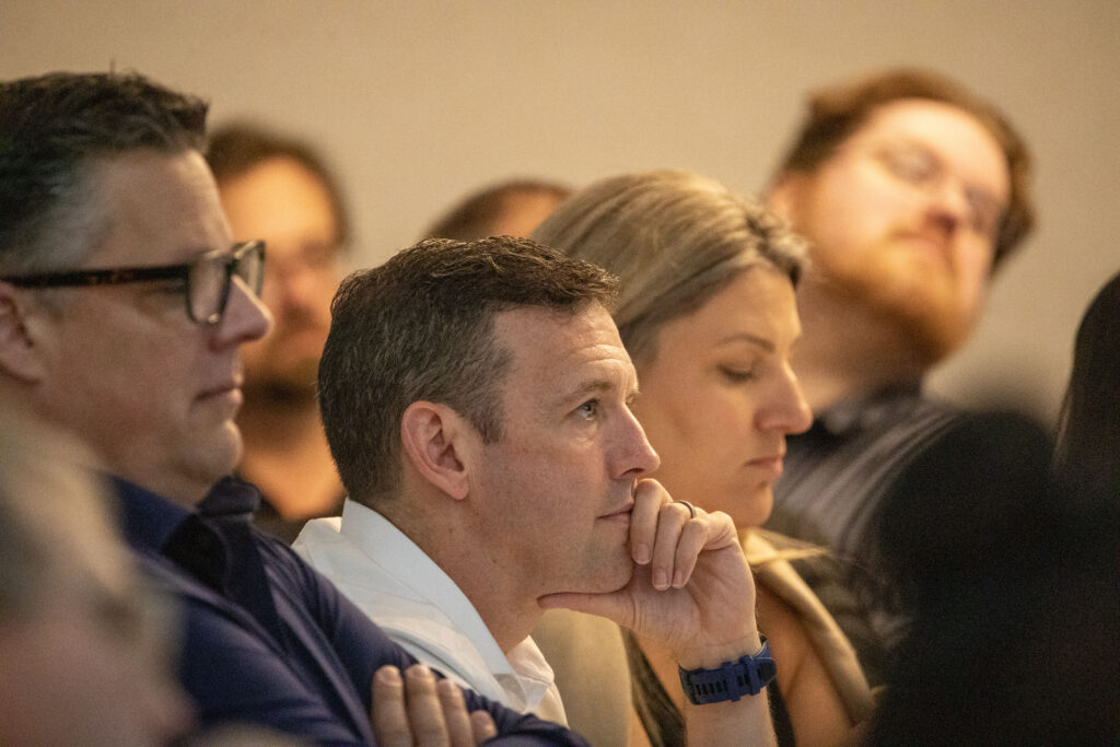 St. Catharines Mayor Mat Siscoe, center, listens to a presentation