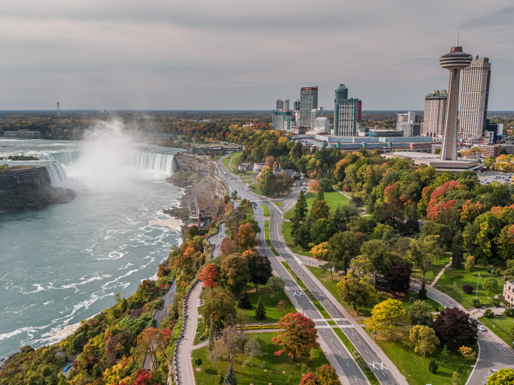 An aerial photograph of the Niagara Parkway with Niagara Falls in the background