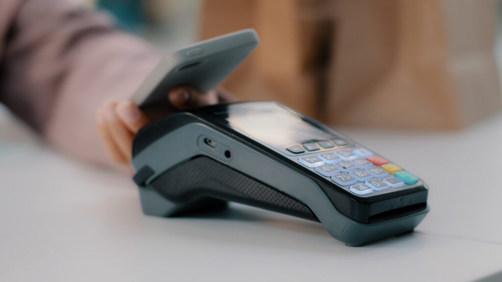 A woman pays for a purchase with a phone