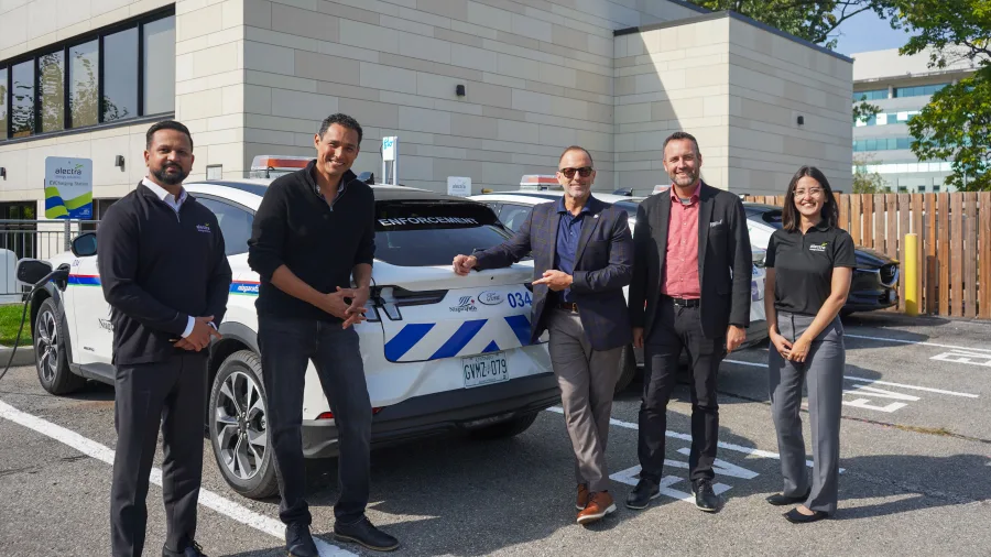 The Mayor of Niagara Falls and city staff outside a new EV charging station 