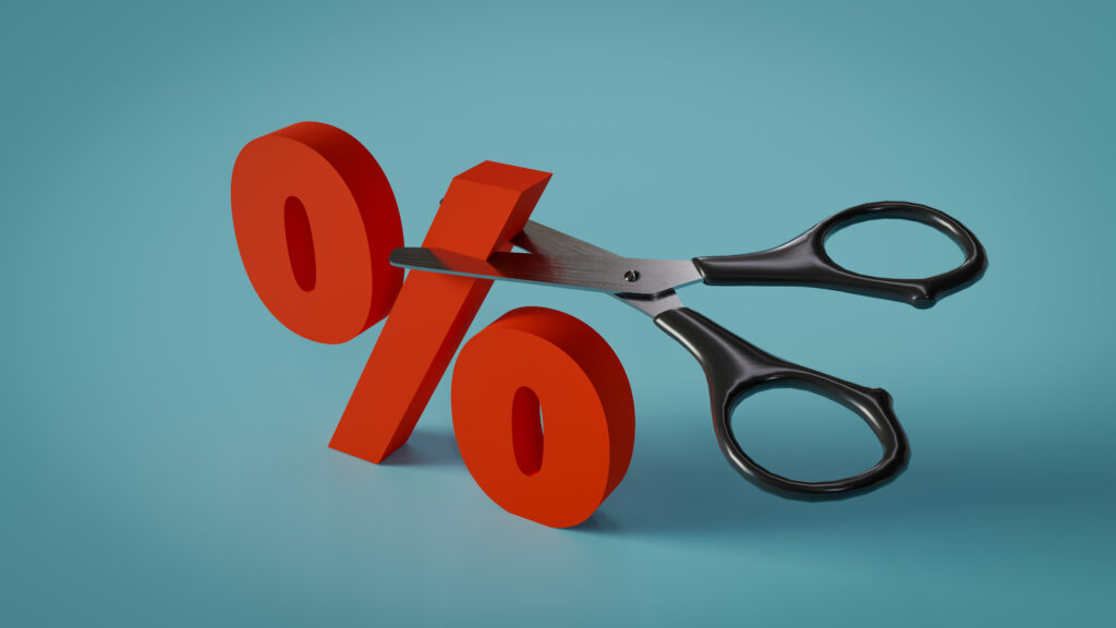 A pair of scissors cutting into a three-dimensional percentage sign