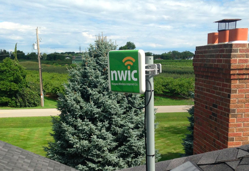 A wireless internet antenna on the roof of a house