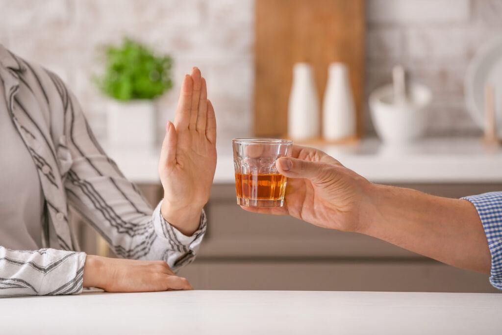 A woman refusing an alcoholic drink