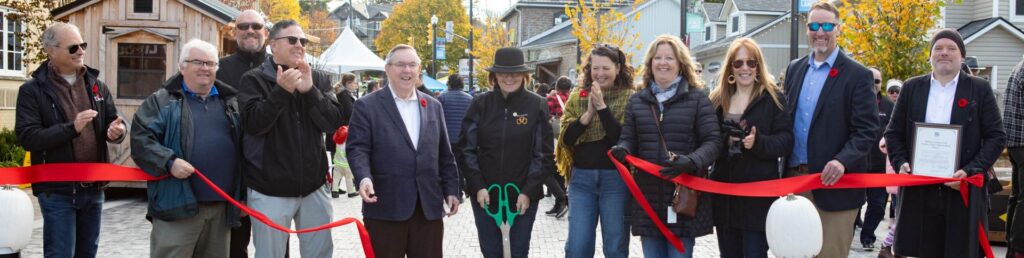 Local dignitaries cut the ribbon opening Jordan Village