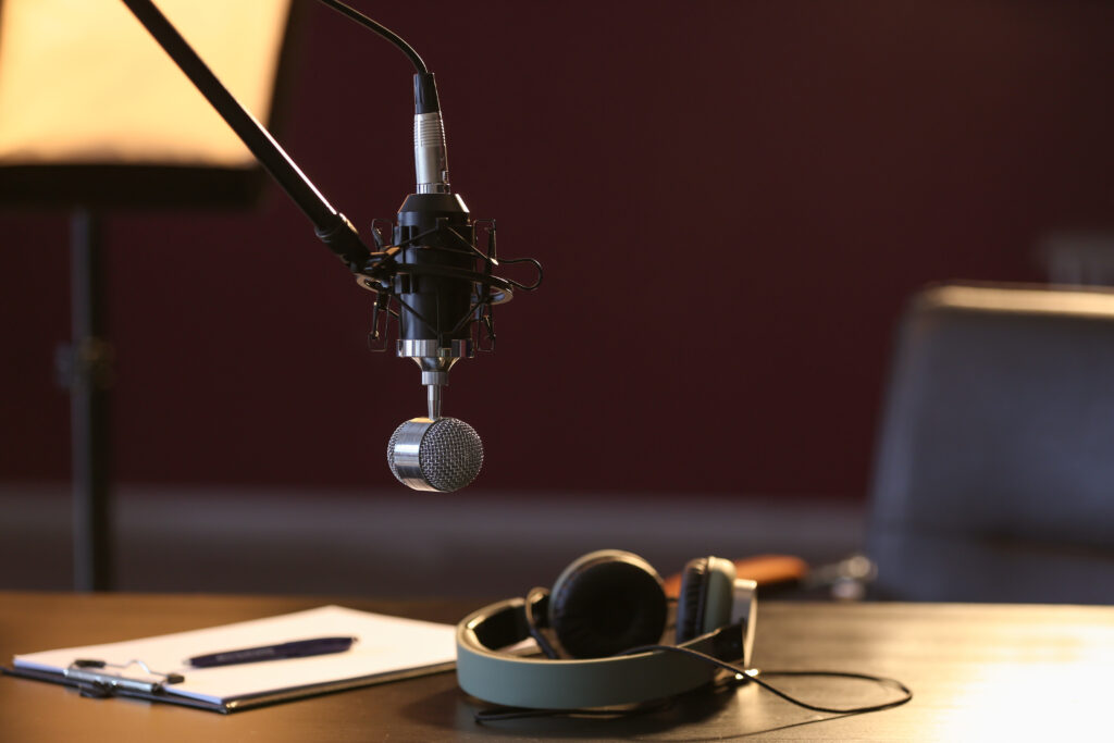 Table with headphones and microphone in radio station