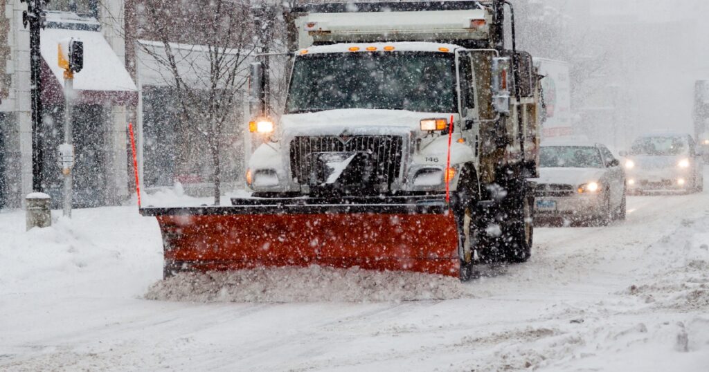 A snow plow clears a street in Thorold during a snowstorm