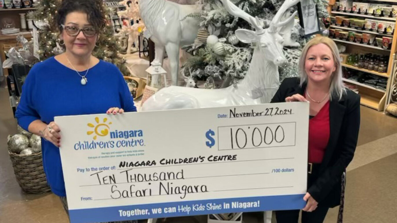 Representatives from Safari Niagara and Niagara Children's Centre hold a novelty cheque