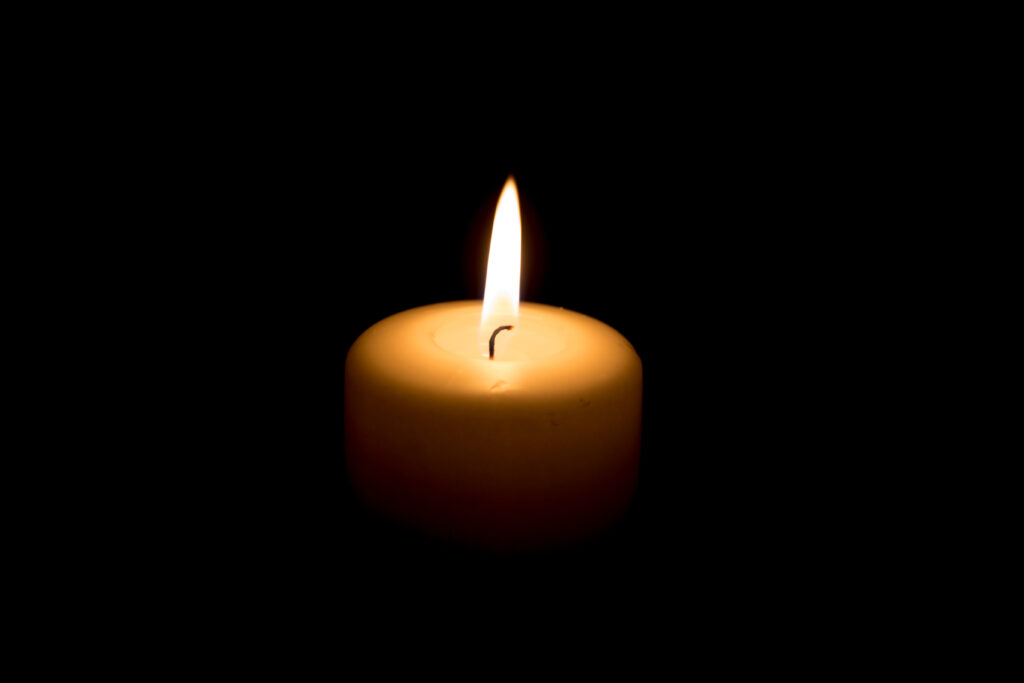 A candle flame in darkness