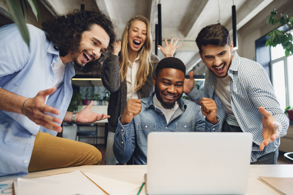 Happy overjoyed business team celebrate corporate victory in their office