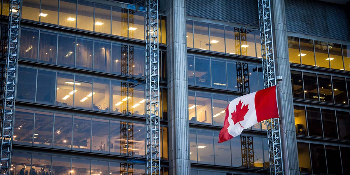 flag of canada in front of the building